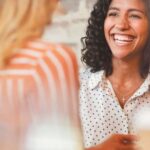 lady smiling in conversation with someone