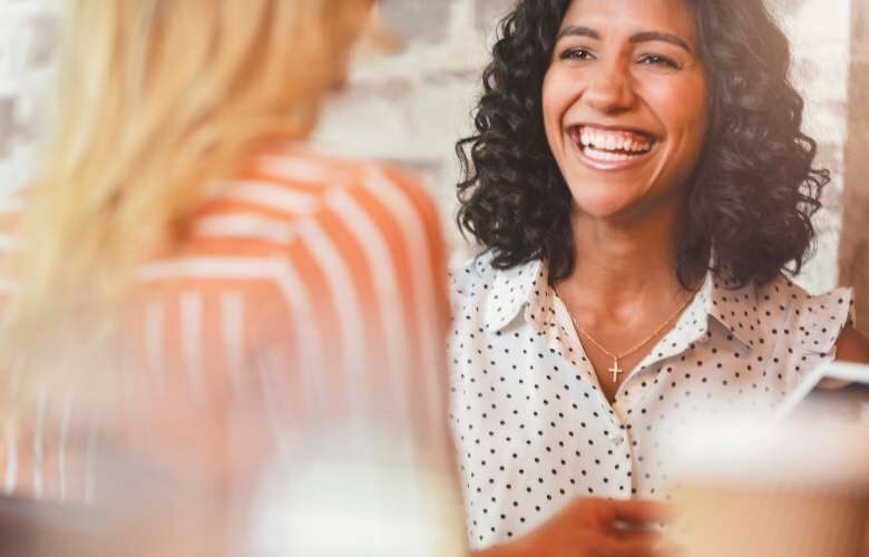 lady smiling in conversation with someone